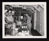 USS Saratoga birthday party, men receiving food in galley 